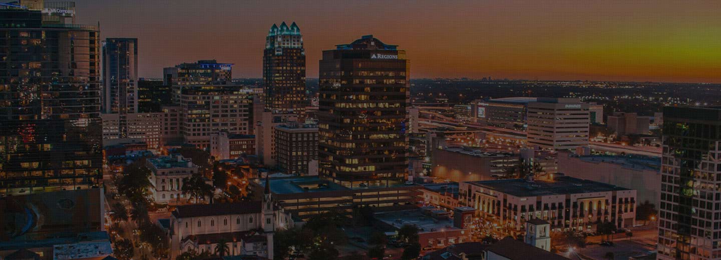 Aerial night view of Orlando’s high-rise buildings and city lights